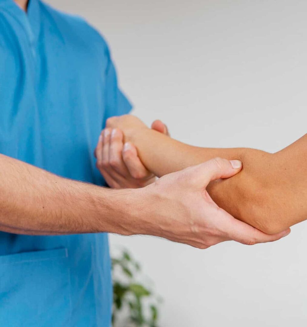 manipulacja powięzi wg Stecco - fizjoterapeuta masuje rękę pacjenta